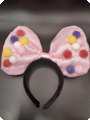 Large pink bow with colored balls headband.